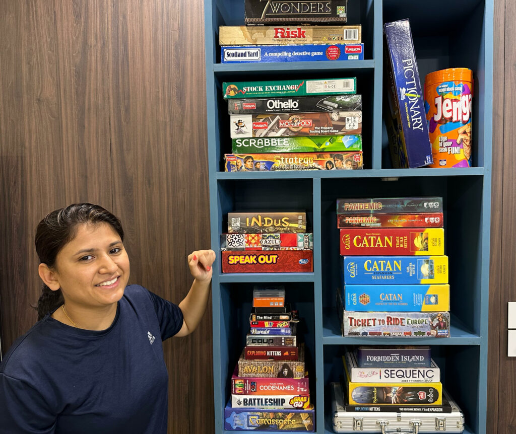 Meghana with her collection of board games.