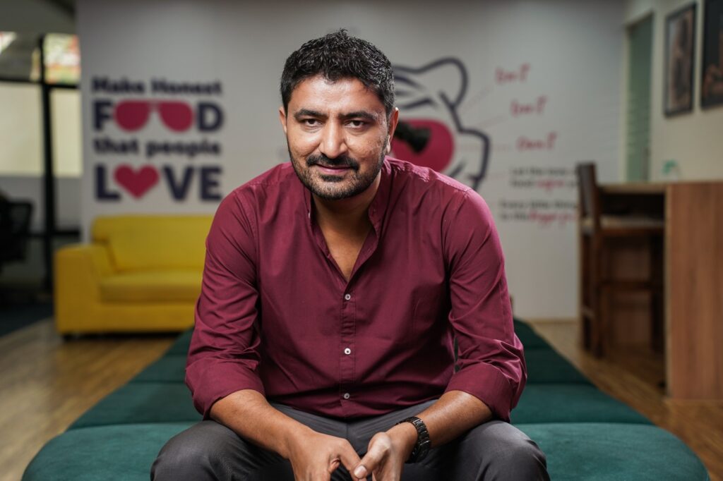 Yadu Nandan, owner of the Bangalore-based restaurant Rolls on Wheels. - Man Sitting on a chair.