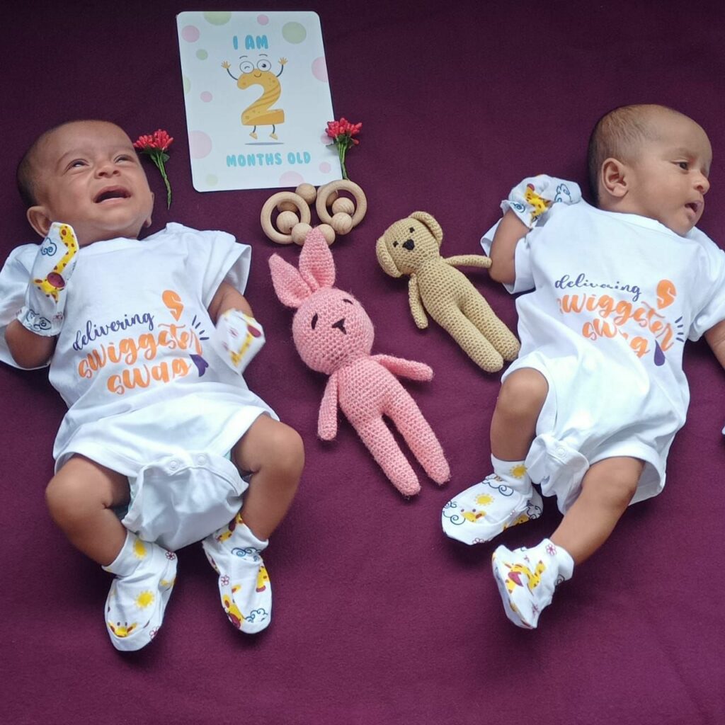 Sowmya's twin baby boys in wearing onesies from Swiggy's gift hamper.