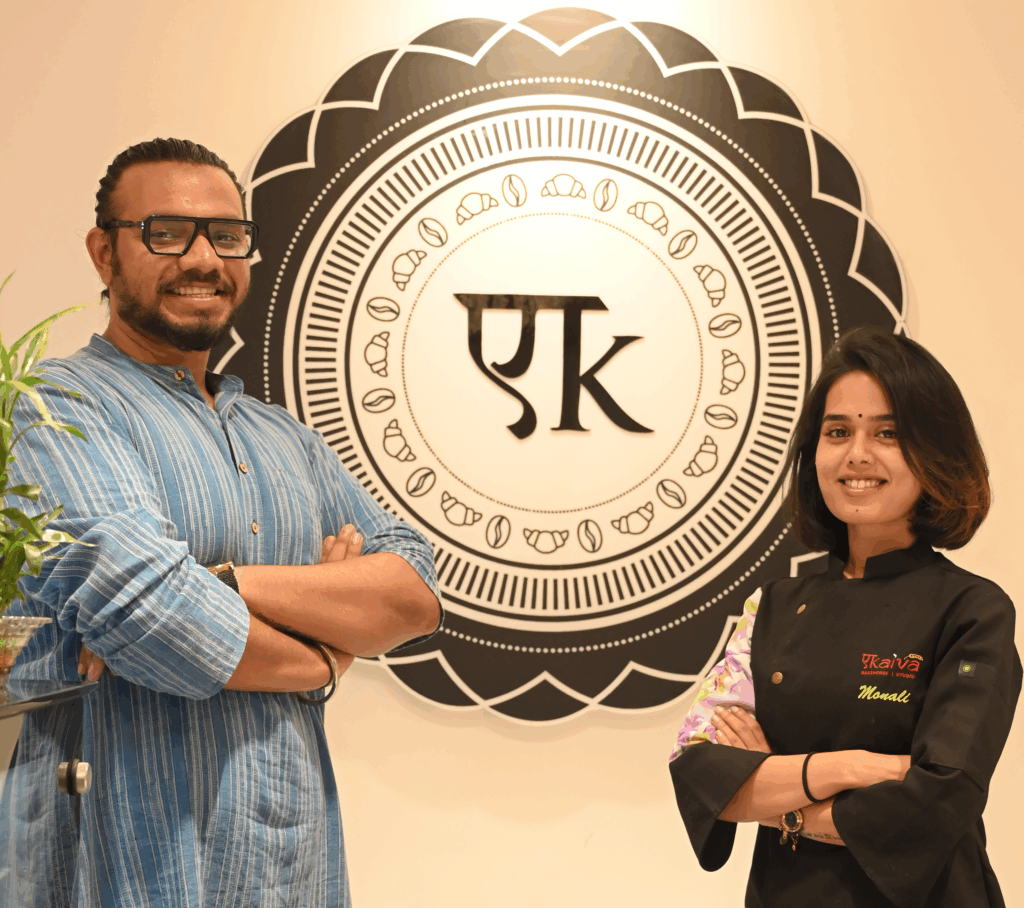 Two people standing side by side, owners of Ekaiva Bakehouse. On the left is Abhineet Patnaik, and on the right is co-founder Monali Panda